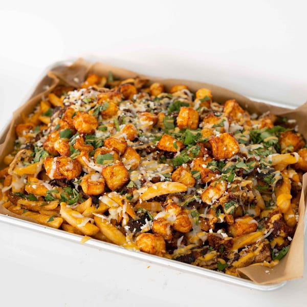 Tiagos Tacos loaded fries with crispy tater tots, melted cheese, and fresh cilantro.